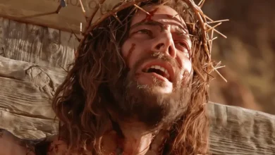 Close-up of Jesus Christ wearing a crown of thorns during crucifixion, a scene from the Gospel of John film.